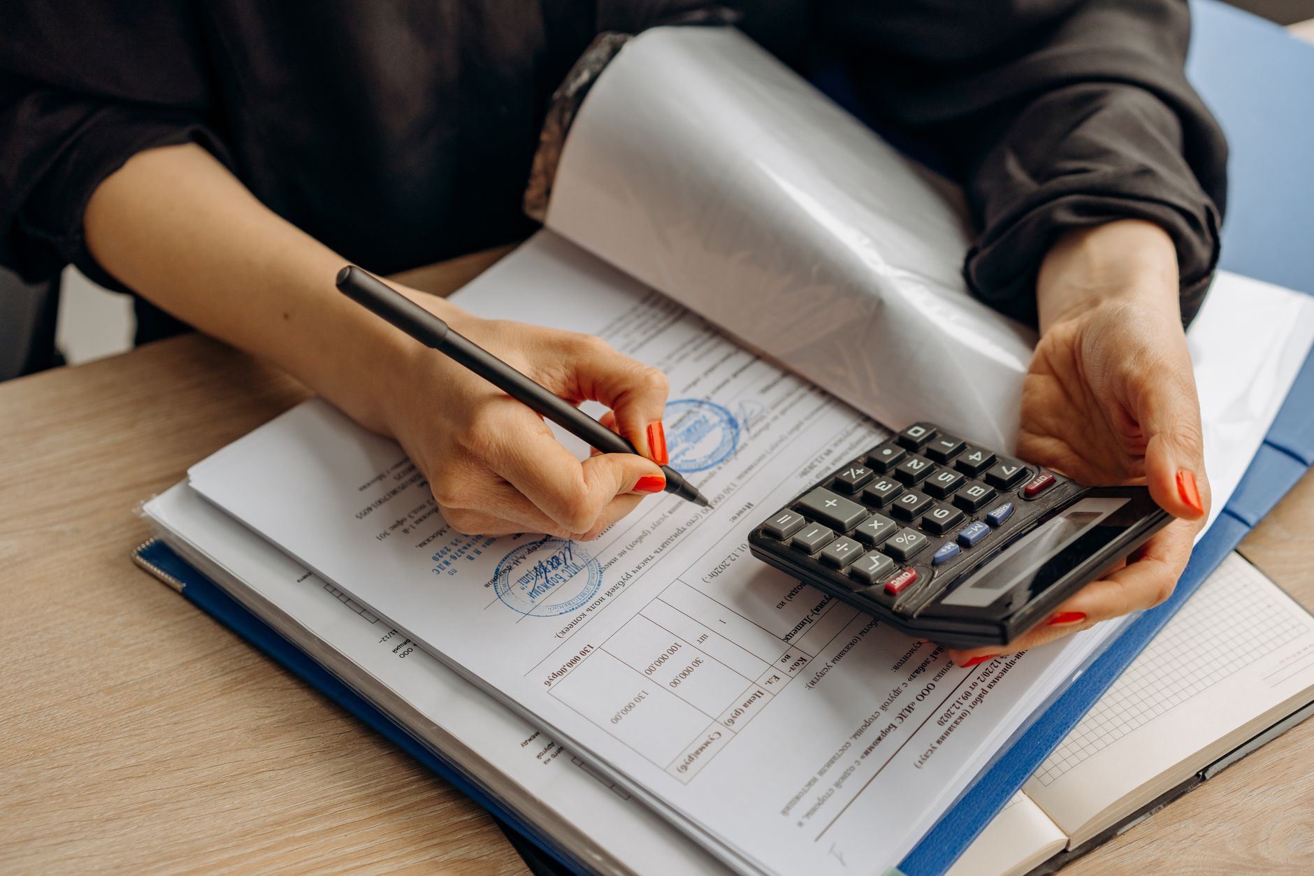 How Renting Works in Japan: Guarantors, Fees and the Paperwork — Japanese apartment rental contract papers and calculator on a small desk