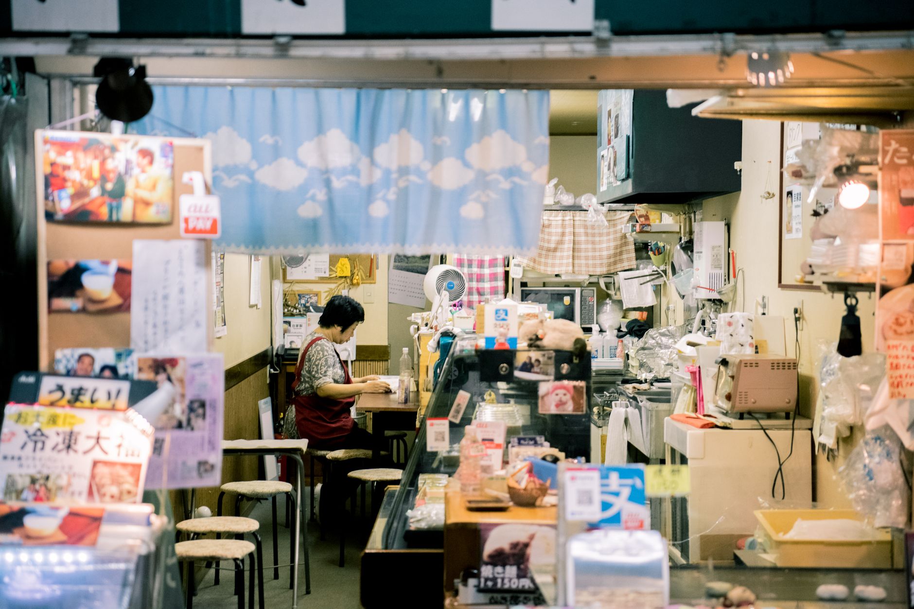 Kansai-ben: Why Osaka Sounds Different — Osaka neighborhood shop counter with Japanese clerk speaking to customer